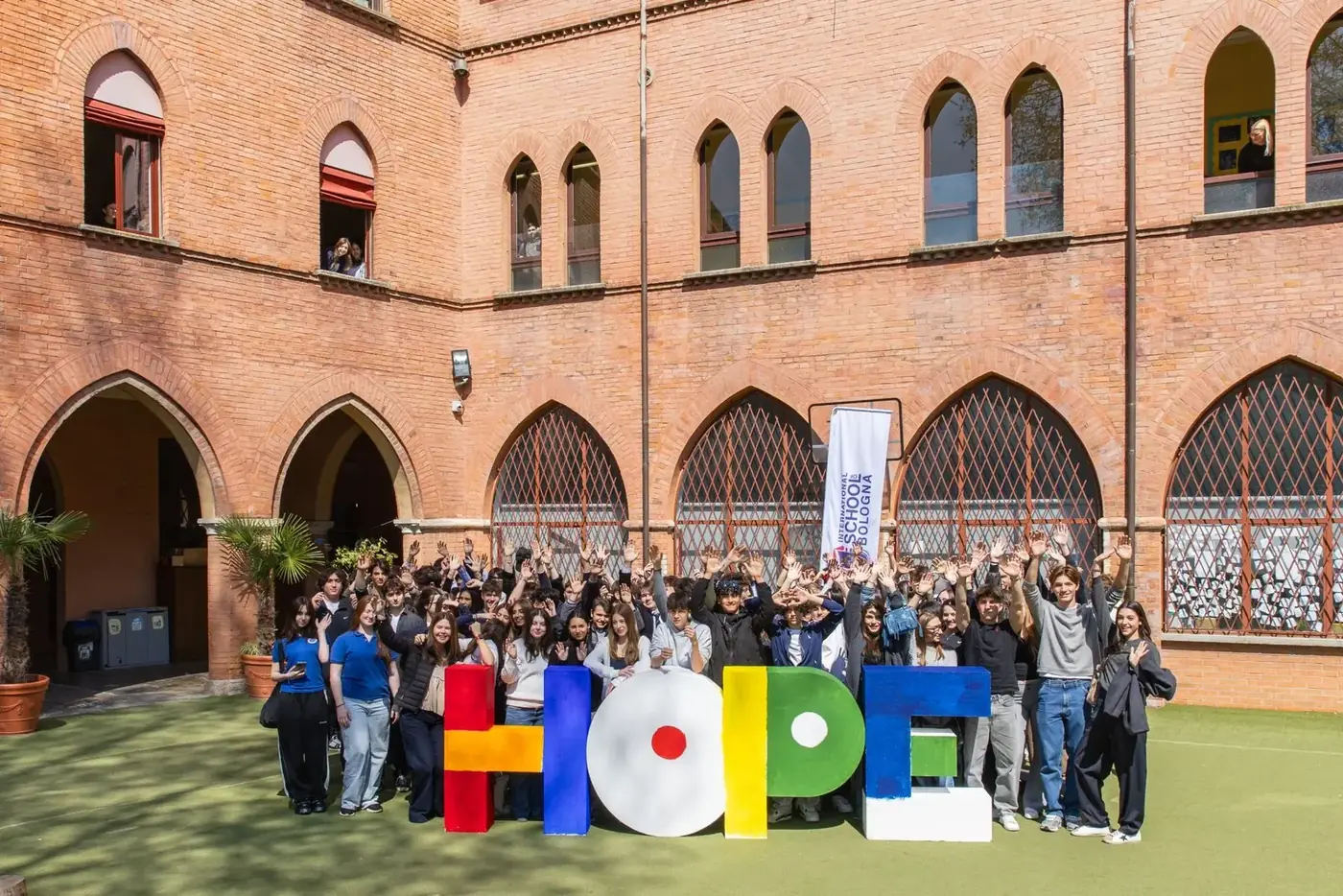 Students from member schools gathered behind large painted letters spelling HOPE
